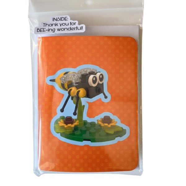 Complete bee card and LEGO brick build set showing card alongside all included pieces