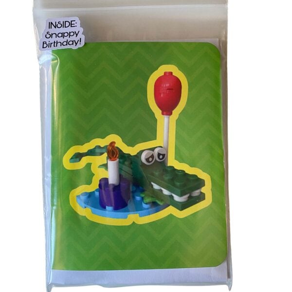 Complete crocodile card and LEGO brick build set showing card alongside all included pieces