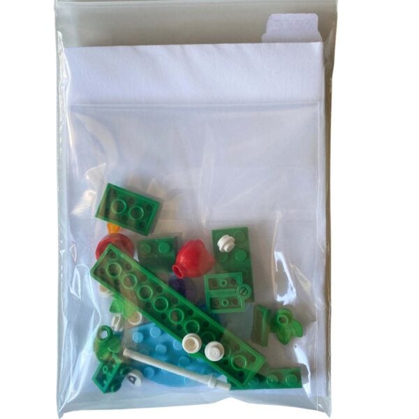 Pieces - Bricks and BooksIndividual LEGO pieces for the mini crocodile brick build laid out beside the greeting card